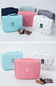 Close-up of hanging travel toiletry bags in various colors and cactus patterns