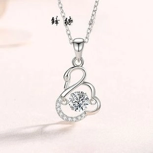 Detailed view of S925 silver swan necklace with dancing moissanite stone and pave crystals