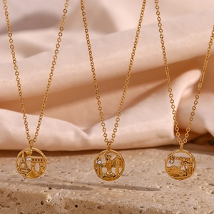 Detailed close-up of golden round city landmark pendants with Eiffel Tower and Statue of Liberty