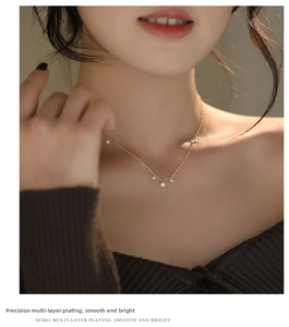 Close-up of gold S925 sterling silver necklace featuring five sparkling zircon pendants