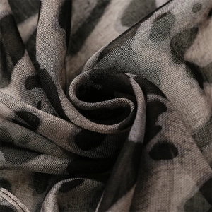 Detail shot of sheer grey leopard print scarf showing soft texture and fine mesh fabric weave