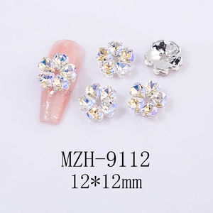 Detail of 12x12mm five-petal nail art charms featuring heart-shaped iridescent rhinestones