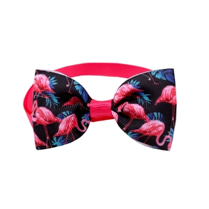 Detail of pink flamingo print pet bowtie with adjustable elastic strap for dogs and cats