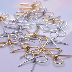 Macro shot of gold and silver 304 stainless steel bow pendants for DIY jewelry making