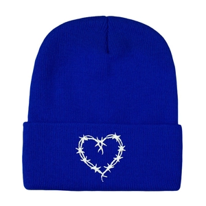 Blue knitted beanie featuring white barbed wire heart embroidery on the front fold