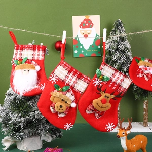 Hanging Christmas stockings featuring 3D Santa, bear, and reindeer festive designs