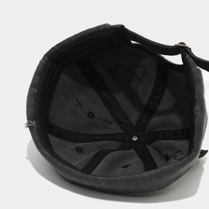 Internal view of a vintage docker hat showing reinforced stitching and metal top button