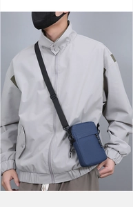 Blue nylon crossbody sling bag with adjustable strap shown on model during outdoor activities
