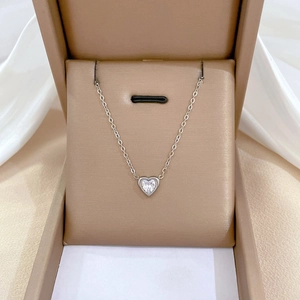 Titanium steel heart pendant necklace with clear crystal in a beige jewelry gift box