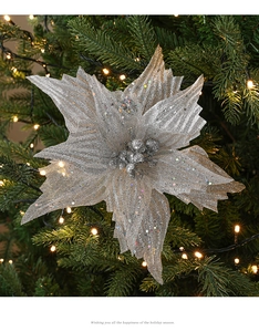 Detailed view of silver glitter poinsettia flower ornament on a Christmas tree