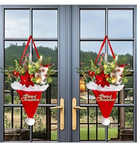 Close-up of lighted Christmas hat door hanger with pine needles and festive ornaments