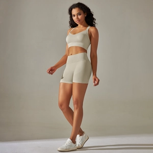 Detailed texture of seamless knit sports bra and high-waist shorts in light khaki