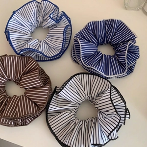 Set of four striped fabric oversized scrunchies in blue, white and brown colors