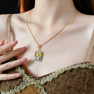 Close-up of vintage floral pendant necklace with freshwater pearls on elegant model's neck
