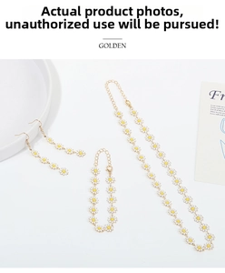 Detail of daisy jewelry set with necklace, bracelet and earrings on decorative dish