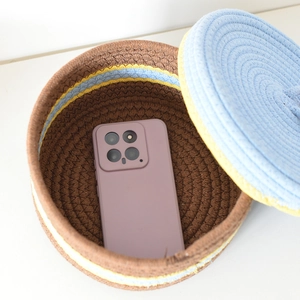 Top view of handwoven cotton rope storage basket with lid showing spacious interior for phone