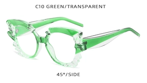 Detail view of green cat-eye sunglasses with unique jagged crystal-cut edges at 45-degree angle