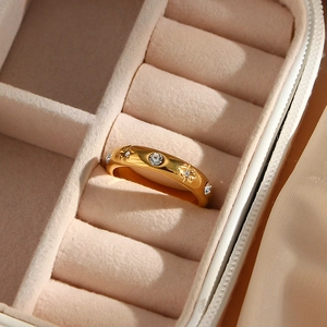 Detailed macro view of 18K gold plated flower ring with clear zircon in a velvet jewelry box