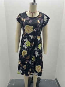 Detail of floral print tiered dress featuring ruffle sleeves and yellow rose pattern