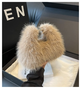 Detail of soft faux fox fur shoulder bag with elegant silver metallic buckles on handles