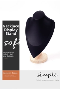 Detail of black leather necklace bust display with a natural wooden base for jewelry
