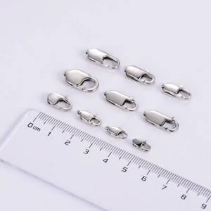 Various sizes of polished stainless steel lobster clasps with measurement ruler guide