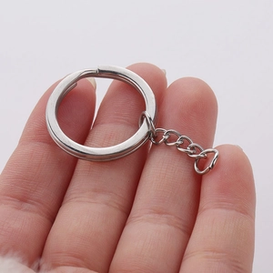 Close-up of a 25mm polished stainless steel flat key ring with extension chain link