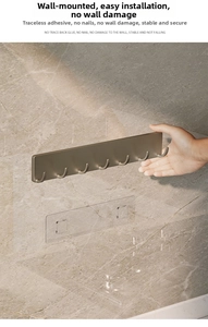Close-up of matte champagne gold wall hooks being installed on marble surface