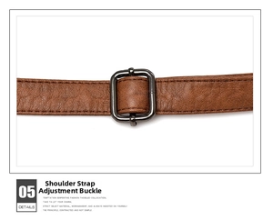 Close-up of brown leather shoulder strap with a dark grey adjustable metal buckle