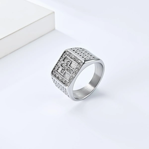Detailed view of silver signet ring with engraved cross and pave-set sparkling crystals