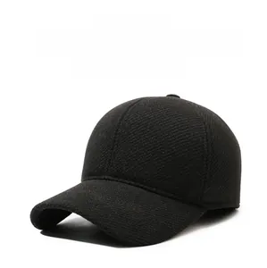 Detailed view of black winter baseball cap with thick twill fabric and ear protection