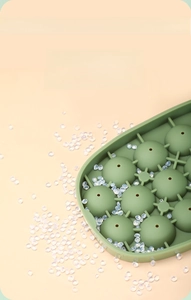 Detail of green food-grade silicone ice mold featuring hemispherical cavities for ice balls