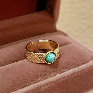 Macro detail of vintage gold quilted ring featuring a center turquoise stone in velvet box