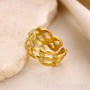 Macro view of gold wave ring with triple layered woven texture on a stone tray