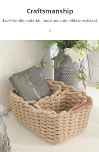 Close-up of hand-woven cotton storage basket with brown leather handles and nordic style