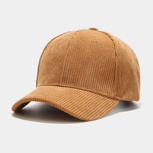 Detail of caramel corduroy texture and curved brim on a retro style baseball cap