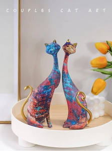 Artistic resin cat figurines with red and blue abstract patterns and gold accents