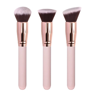 Three-piece pink makeup brush set with rose gold metal ferrules on a white background