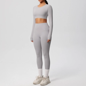 Detail view of high-waist yoga leggings with convenient side pockets in soft grey fabric