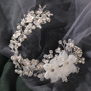 Exquisite bridal hair comb with white flowers, pearls, and crystals on a silver wire