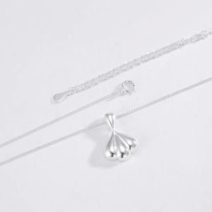 Macro shot of polished S925 sterling silver shell pendant with adjustable chain closure