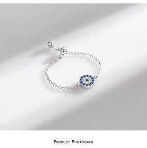 Detailed macro of S925 silver evil eye chain ring with blue stones and crystals