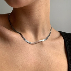 Close-up of a 4mm silver flat snake chain necklace worn on a neck for a sleek hip hop look