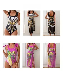 Detail view of one-piece swimsuits with geometric prints and mesh skirts for women