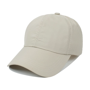 Detailed macro view of beige ponytail baseball cap featuring breathable mesh and neat stitching
