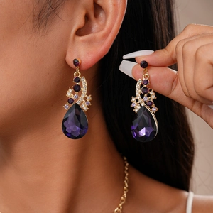Vintage gold teardrop earring set with large purple gemstones and sparkling crystals