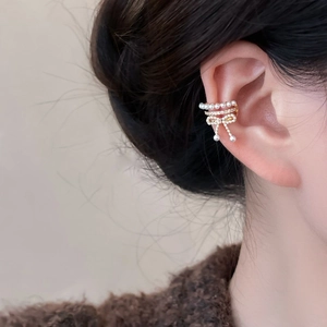 Elegant zircon bow and pearl ear cuff in golden finish with three-layer wrap design