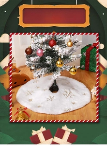 Detailed view of white faux fur Christmas tree skirt with golden sequin snowflake embroidery