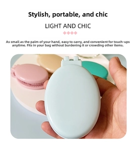 Close-up of portable folding hair brush with mirror in pastel colors for travel use
