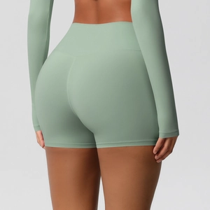 Detail view of high waisted sage green yoga shorts with scrunch butt lifting seams